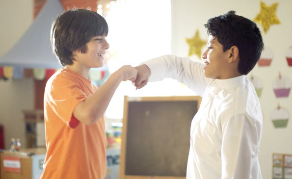 Two children greeting each other with a fist. About healthy relationships.